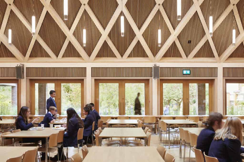 View looking out of windows from timber interior of school refectory