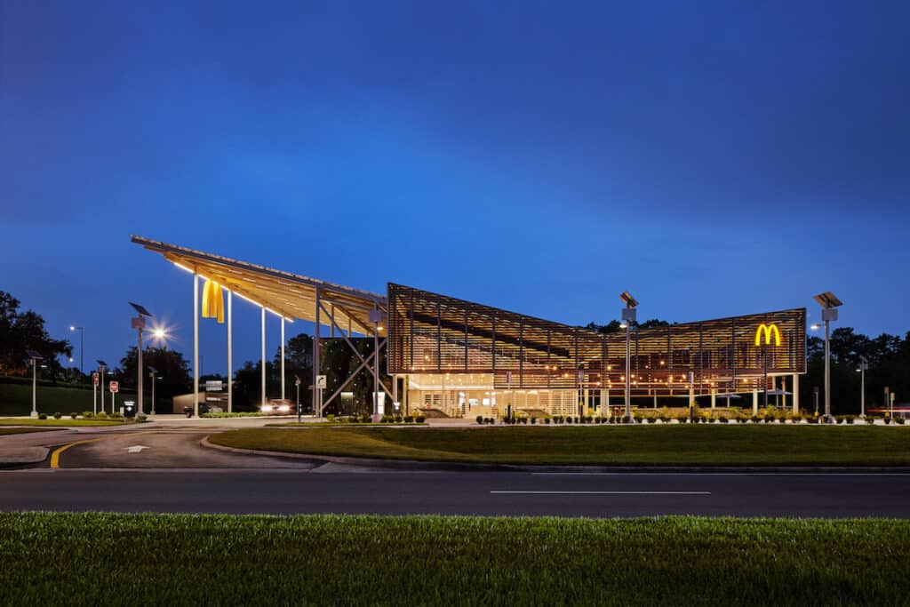 Side elevation showing Kebony louvred exterior of McDonald’s Flagship-Disney restaurant, in Orlando (at night)